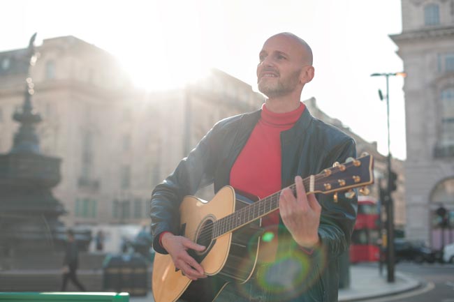 bald singing musician
